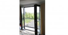 opening patio doors to balcony with mountain views
